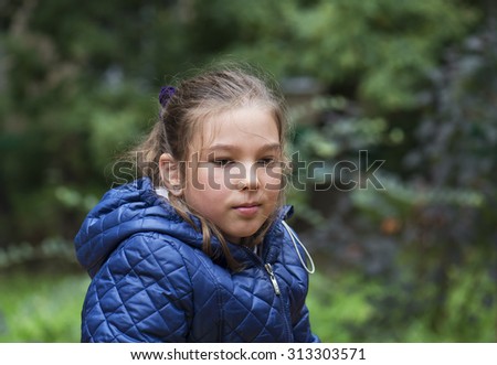 Outdoor portrait of a little girl in autumn jacket