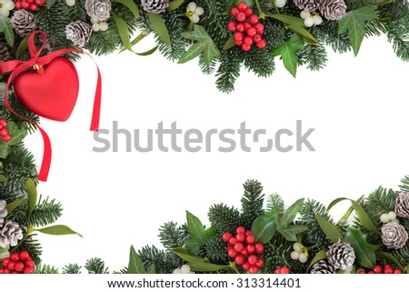 Christmas abstract background border with red heart bauble decoration, holly, ivy, mistletoe, pine cones and  blue spruce fir over white.