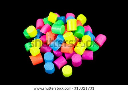 Multicolored polymer clay pieces isolated on the black background