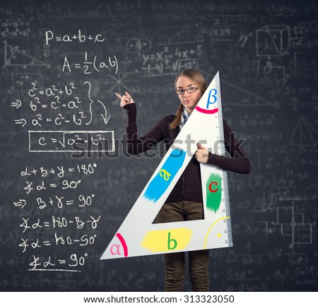 female student with a big ruler pointing at  Pythagorean theorem on blackboard