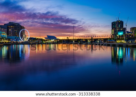 Darling Harbour in Sydney on a winters evening, with the highrise buildings being built, and the casino and amusement park on the left bank Royalty-Free Stock Photo #313338338