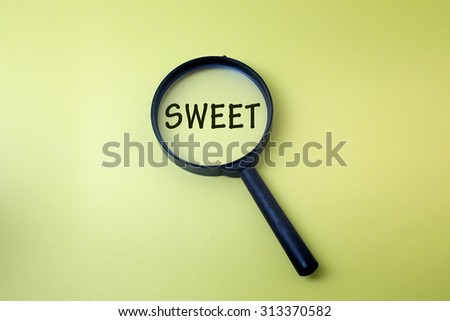 Concept image of magnifying glass showing the SWEET word