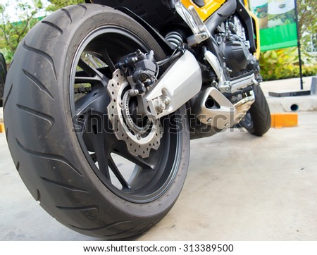 motorcycle fragment.rear wheel sports bike.motorcycle tyre big bike.closeup rear wheel of bigbike motorcycle. 