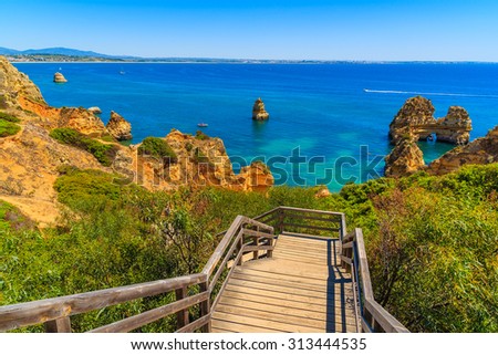 Wooden walkway to Ponta da Piedade beach, Algarve region, Portugal Royalty-Free Stock Photo #313444535