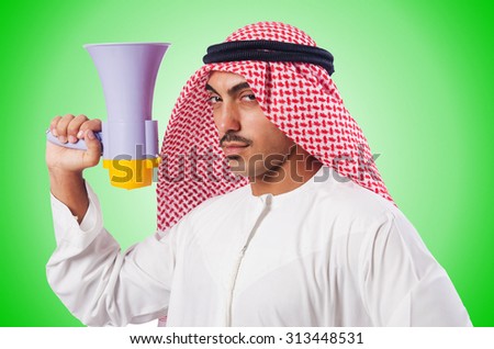 Arab man shouting through loudspeaker Royalty-Free Stock Photo #313448531