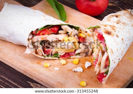 Chicken, Mushroom, Cheese and Spinach Burritos. Glass of Beer