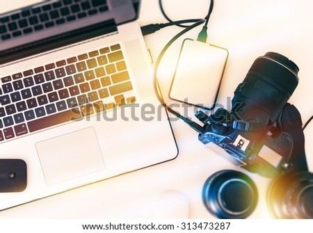 Digital Photography Workstation From Above. Modern Digital Camera, Lenses and Laptop Computer.