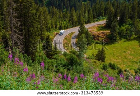 Camper Van Summer Travel. Rving Photo Theme. Small Class C Travel Camper on a Mountain Road During Summer Time. Royalty-Free Stock Photo #313473539