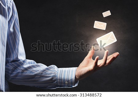 Close up of businessman holding email icon in palm