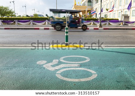bike lane with tuk tuk motion blur in bangkok