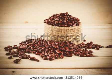 red  beans on wood background - soft focus with vintage film filter