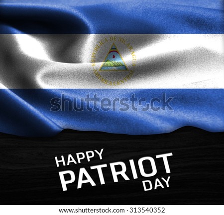 Happy Patriot Day Nicaragua flag on wood Texture background
