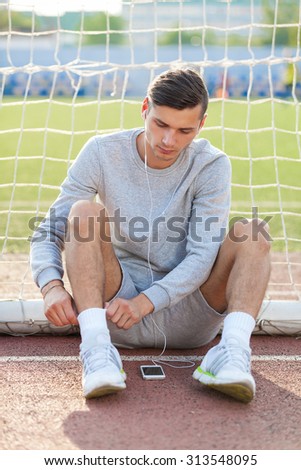 Portrait of a determined young runner at the soccer field