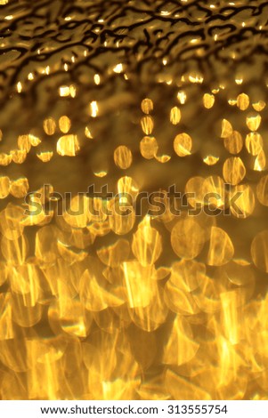 Closeup of beautiful glossy bright abstract gold metal shiny empty bokeh copyspace background with sparkles, vertical picture