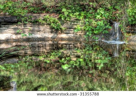 little pond with waterfall  and goldfish makes a pretty picture