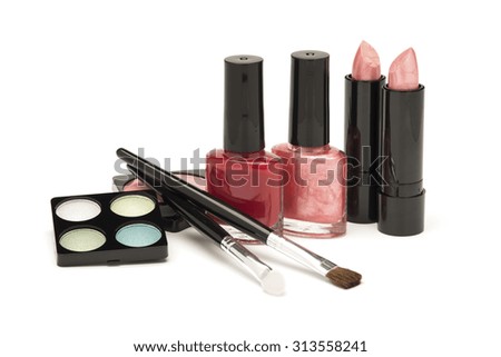 Pink and red lipsticks and nail polish with green and blue eye shadow and accessories