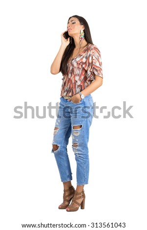 Relaxed young Indian woman with head leaned back talking on the cellphone. Full body length portrait isolated over white studio background. 