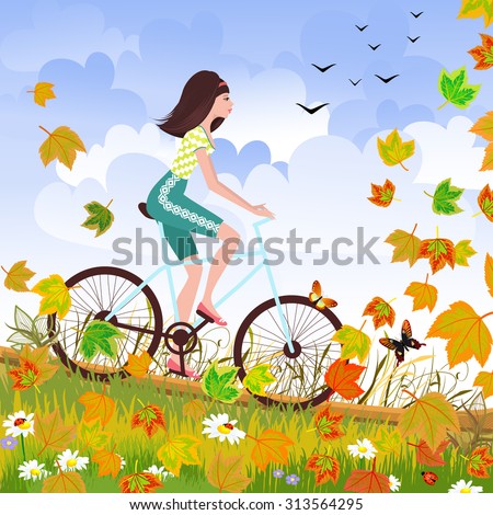 Beautiful girl is riding on a bicycle in a autumn forest.