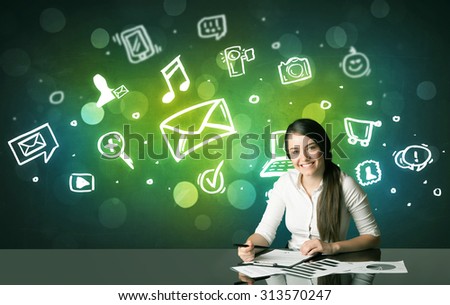 Businesswoman sitting at the black table with social media symbols on the background 