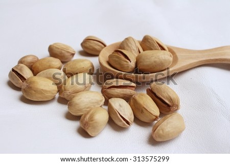 Pistachios nuts on a background of white