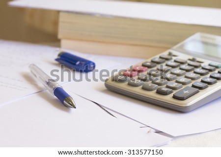 pen and calculator on table. shallow depth of field
