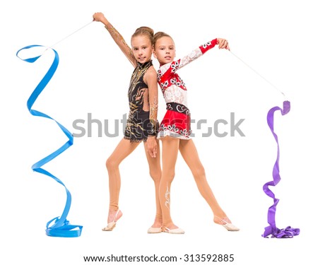 Girls engaged art gymnastic. Twins girls with colored ribbon on white background.
