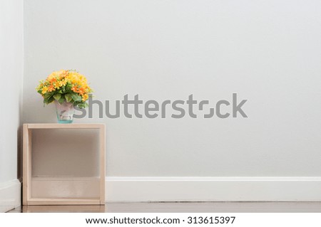 Artificial flower on the square wooden box. Royalty-Free Stock Photo #313615397