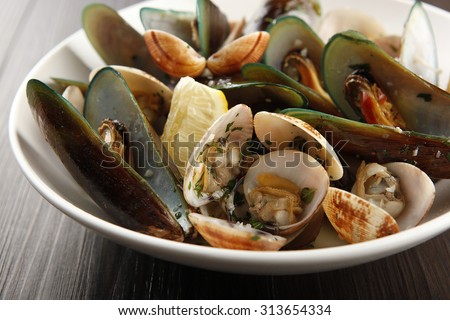 Assorted shellfish on a bowl.  Royalty-Free Stock Photo #313654334