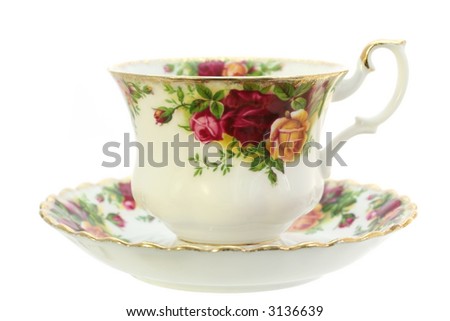 A classic gold-rimmed floral china teacup and saucer.  Isolated on white. Royalty-Free Stock Photo #3136639