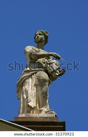 Statue of a powerful woman carrying head of a man