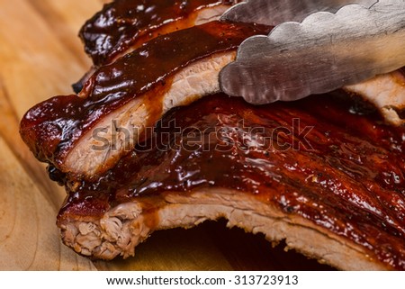nice serving of bbq ribs on cutting board Royalty-Free Stock Photo #313723913