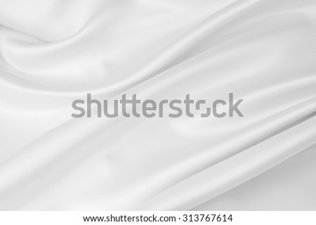 Closeup of rippled white silk fabric Royalty-Free Stock Photo #313767614