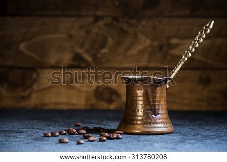 vintage coffee maker and beans on wooden background