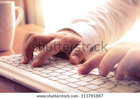 Businessman typing on computer keyboard at office. Image can be used for background, website banner, promotional materials, poster, presentation templates, advertising and printed materials.