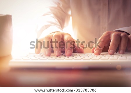 Closeup of man's hands typing on keyboard. Image can be used for background, website banner, promotional materials, poster, presentation templates, advertising and printed materials.