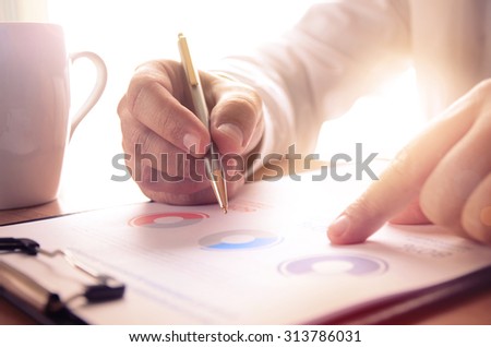 Businessman study financial report. Concept for business, finance, market research, analytics and statistics, marketing. Royalty-Free Stock Photo #313786031