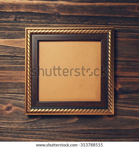 ancient style golden photo image frame on wood background 