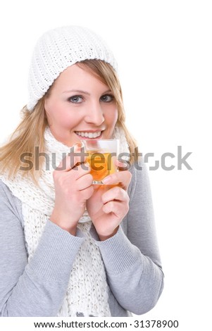 Full isolated studio picture from a young woman with winter clothes having a tea