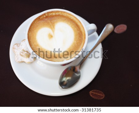 Coffee cup with milk and heart shape