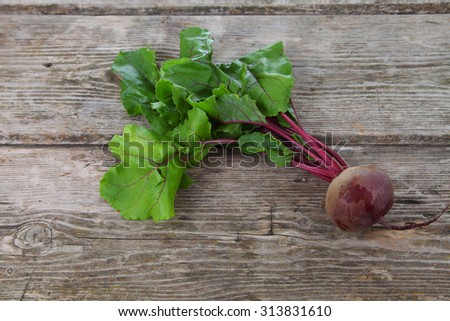 Beetroot with leaves on a wooden background