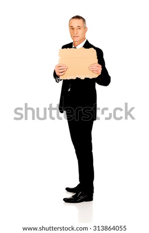 Mature businessman with a piece of cardboard
