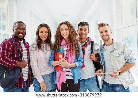 Happy college students looking at camera with smiles