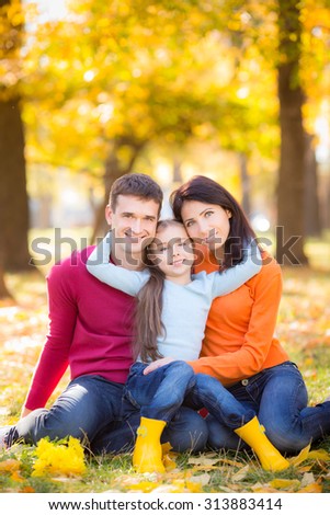 Happy family having fun outdoors in autumn park