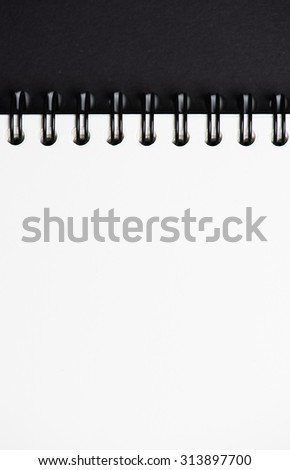 white notepad with black cover