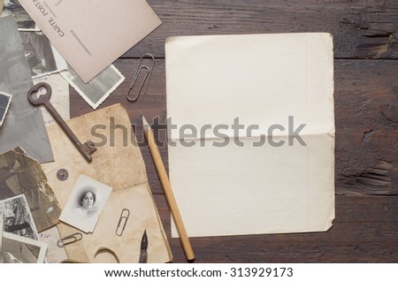 old photos and letters on the wooden table