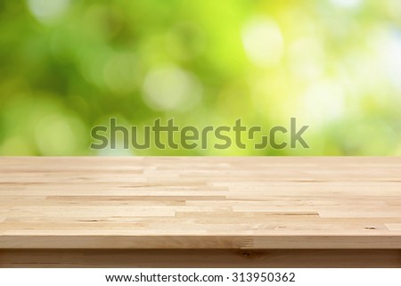 Wood table top on bokeh abstract green background  - can be used for montage or display your products