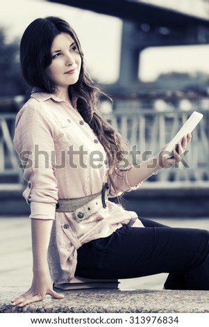 Young fashion woman with digital tablet computer outdoor