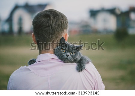 Close up view of man holding a cat