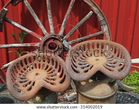 Old Wooden Wagon Wheel and Two Metal Seats