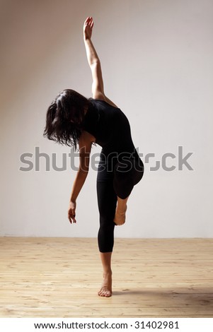 modern style dancer posing on studio background